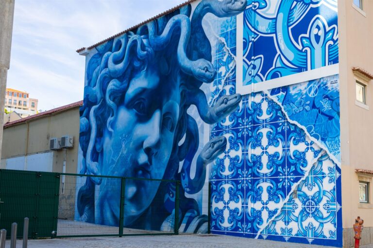 A large blue and white azulejo mural painted on a wall in Lisbon