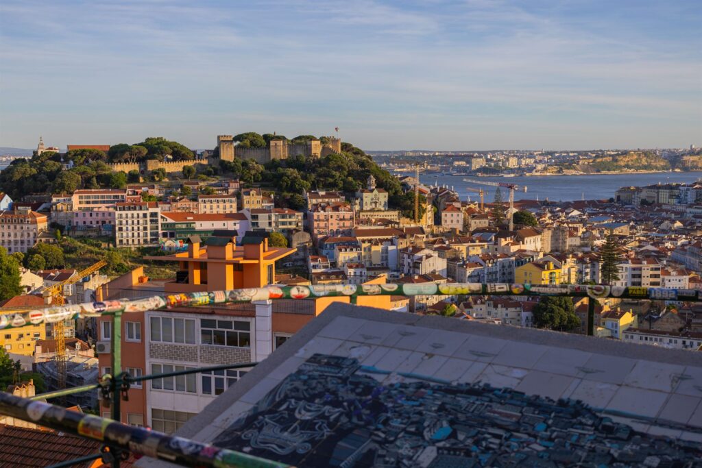 Lisbon rooftops and castle hill in warm late afternoon light