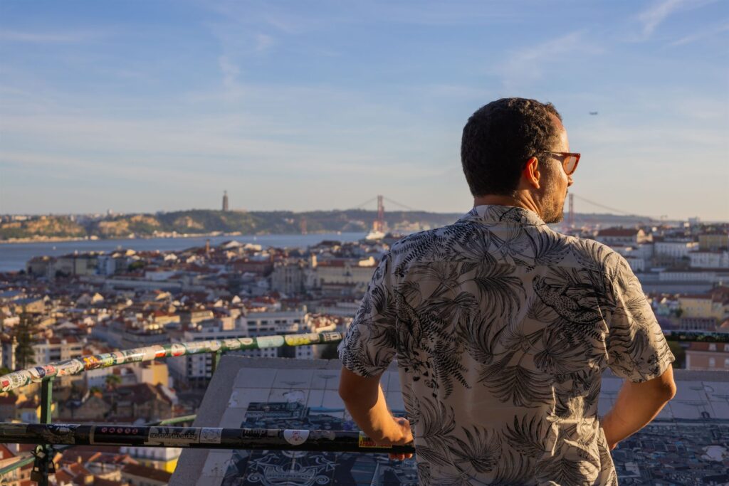 A Chico Chico Tours guide looking out over the rooftops of Lisbon from a viewpoint terrace