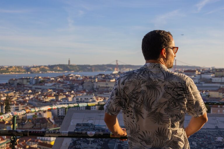 A Chico Chico Tours guide looking out over the rooftops of Lisbon from a viewpoint terrace