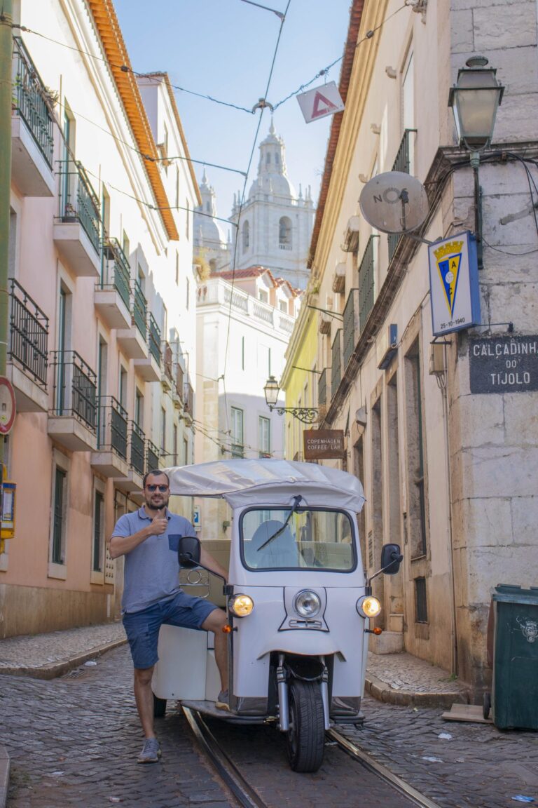 Guide and tuk-tuk in a quiet Alfama alley in the morning