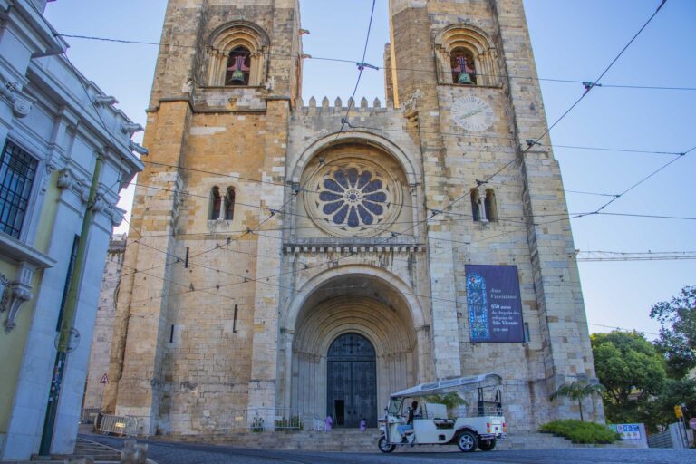 Lisbon Cathedral (Se) with a tuk-tuk on an empty morning street