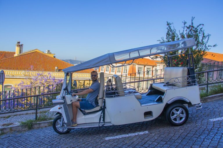 Tuk-tuk at a Lisbon viewpoint with jacaranda in the morning