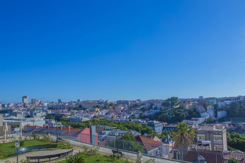 A panoramic view over Lisbon rooftops towards the Tagus river